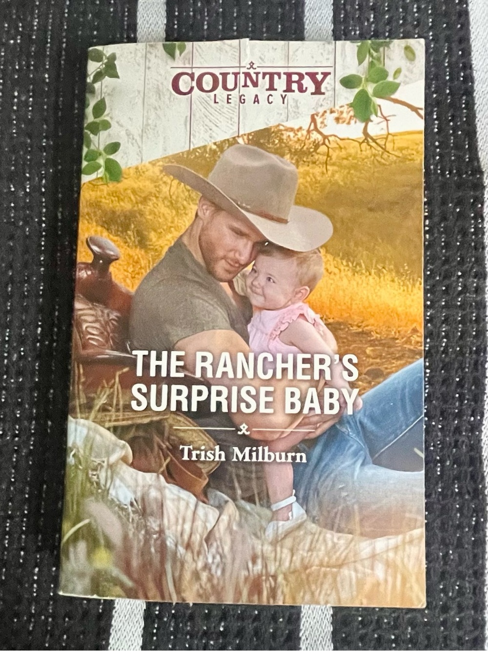 Romance novel The Rancher's Surprise Baby by Trish Milburn